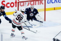 Mar 3, 2026; Winnipeg, Manitoba, CAN; Winnipeg Jets goalie Connor Hellebuyck (37) makes a save against Chicago Blackhawks forward Connor Bedard (98) during the second period at Canada Life Centre. Mandatory Credit: Terrence Lee-Imagn Images
