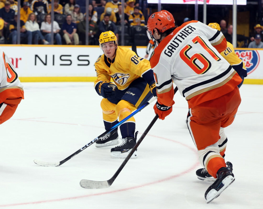 Apr 16, 2026; Nashville, Tennessee, USA; Anaheim Ducks left wing Cutter Gauthier (61) shoots the puck as Nashville Predators defenseman Ryan Ufko (85) defends during the third period of their game at Bridgestone Arena. Mandatory Credit: Alan Poizner-Imagn Images