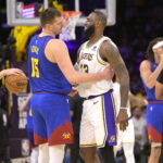 Mar 2, 2024; Los Angeles, California, USA; Los Angeles Lakers forward LeBron James (23) is greeted by Denver Nuggets center Nikola Jokic (15) at the start of the game at Crypto.com Arena. Mandatory Credit: Jayne Kamin-Oncea-USA TODAY Sports
