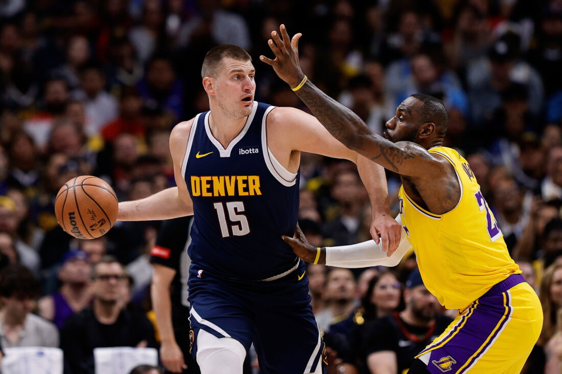Apr 29, 2024; Denver, Colorado, USA; Denver Nuggets center Nikola Jokic (15) controls the ball under pressure from Los Angeles Lakers forward LeBron James (23) in the first quarter during game five of the first round for the 2024 NBA playoffs at Ball Arena. Mandatory Credit: Isaiah J. Downing-USA TODAY Sports
