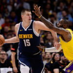 Apr 29, 2024; Denver, Colorado, USA; Denver Nuggets center Nikola Jokic (15) controls the ball under pressure from Los Angeles Lakers forward LeBron James (23) in the first quarter during game five of the first round for the 2024 NBA playoffs at Ball Arena. Mandatory Credit: Isaiah J. Downing-USA TODAY Sports