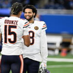 Nov 28, 2024; Detroit, Michigan, USA; Chicago Bears quarterback Caleb Williams (18) greets wide receiver Rome Odunze (15) during pregame warmups before their game against the Detroit Lions at Ford Field. Mandatory Credit: Lon Horwedel-Imagn Images