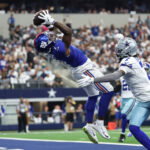Sep 14, 2025; Arlington, Texas, USA; New York Giants wide receiver Malik Nabers (1) makes a catch for a touchdown against Dallas Cowboys cornerback Trevon Diggs (7) during the second quarter at AT&T Stadium. Mandatory Credit: Kevin Jairaj-Imagn Images