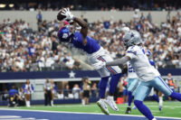 Sep 14, 2025; Arlington, Texas, USA; New York Giants wide receiver Malik Nabers (1) makes a catch for a touchdown against Dallas Cowboys cornerback Trevon Diggs (7) during the second quarter at AT&T Stadium. Mandatory Credit: Kevin Jairaj-Imagn Images
