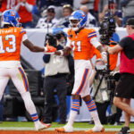 Oct 26, 2025; Denver, Colorado, USA; Denver Broncos wide receiver Troy Franklin (11) celebrates with wide receiver Pat Bryant (13) after scoring a touchdown against the Dallas Cowboys in the fourth quarter at Empower Field at Mile High. Mandatory Credit: Ron Chenoy-Imagn Images