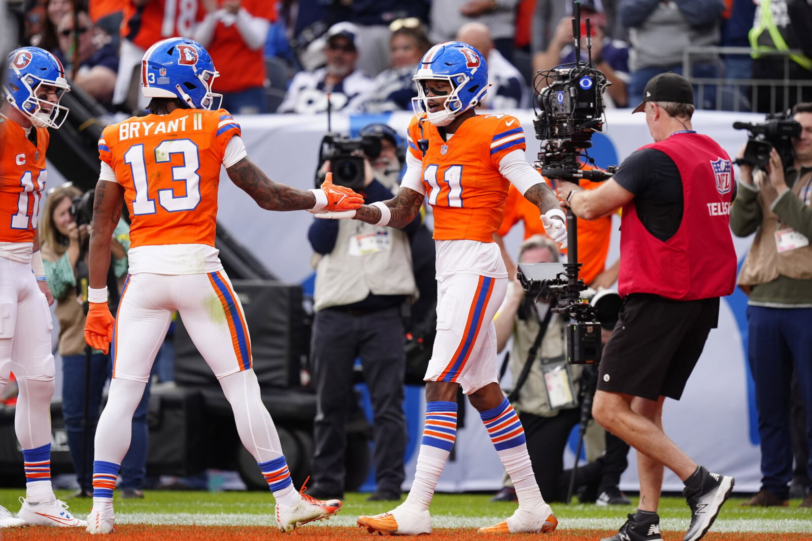 Oct 26, 2025; Denver, Colorado, USA; Denver Broncos wide receiver Troy Franklin (11) celebrates with wide receiver Pat Bryant (13) after scoring a touchdown against the Dallas Cowboys in the fourth quarter at Empower Field at Mile High. Mandatory Credit: Ron Chenoy-Imagn Images