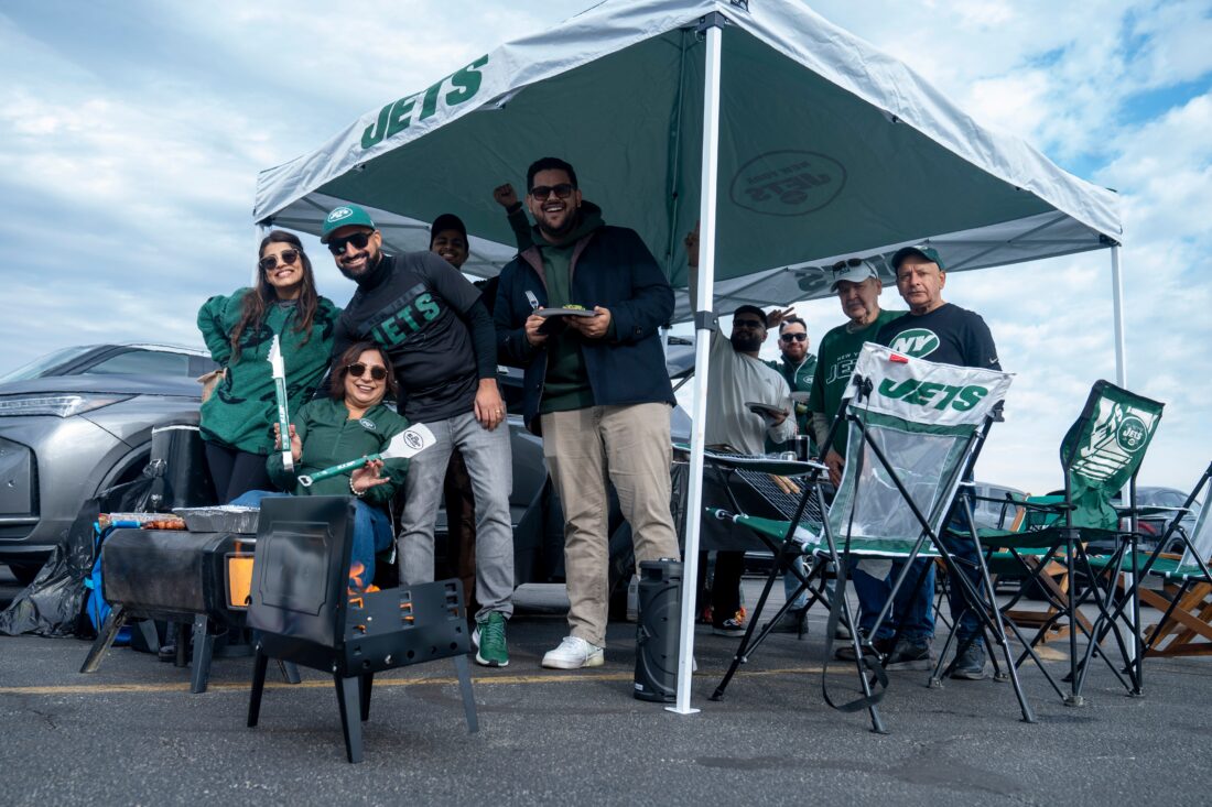 A group of fans stand for a photo while tailgating before an NFL Week 10 game between the New York Jets and the Cleveland Browns at MetLife Stadium on Sunday, Nov. 9, 2025. Credit: Julian Leshay Guadalupe/NorthJersey.com / USA TODAY NETWORK via Imagn Images