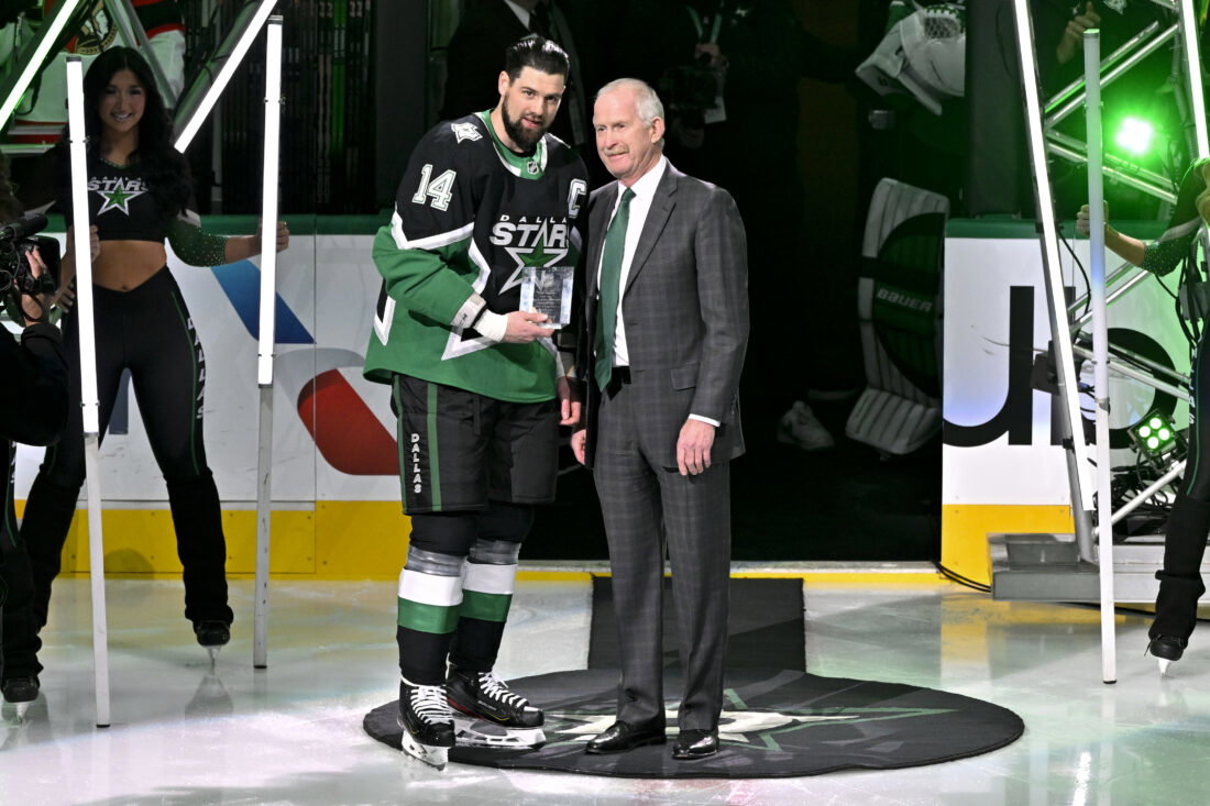 Nov 30, 2025; Dallas, Texas, USA; Dallas Stars general manager Jim Nill (right) presents left wing Jamie Benn (14) with a plaque commemorating Benn scoring his 400th goal before the game between the Dallas Stars and the Ottawa Senators at the American Airlines Center. Mandatory Credit: Jerome Miron-Imagn Images