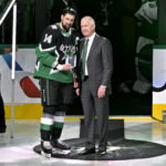 Nov 30, 2025; Dallas, Texas, USA; Dallas Stars general manager Jim Nill (right) presents left wing Jamie Benn (14) with a plaque commemorating Benn scoring his 400th goal before the game between the Dallas Stars and the Ottawa Senators at the American Airlines Center. Mandatory Credit: Jerome Miron-Imagn Images