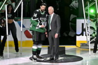 Nov 30, 2025; Dallas, Texas, USA; Dallas Stars general manager Jim Nill (right) presents left wing Jamie Benn (14) with a plaque commemorating Benn scoring his 400th goal before the game between the Dallas Stars and the Ottawa Senators at the American Airlines Center. Mandatory Credit: Jerome Miron-Imagn Images