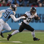 Nov 30, 2025; Nashville, Tennessee, USA; Jacksonville Jaguars running back Bhayshul Tuten (33) runs with the ball against the Tennessee Titans during the second half at Nissan Stadium. Mandatory Credit: Steve Roberts-Imagn Images