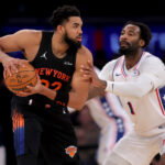 Dec 19, 2025; New York, New York, USA; New York Knicks center Karl-Anthony Towns (32) controls the ball against Philadelphia 76ers center Andre Drummond (1) during the third quarter at Madison Square Garden. Mandatory Credit: Brad Penner-Imagn Images