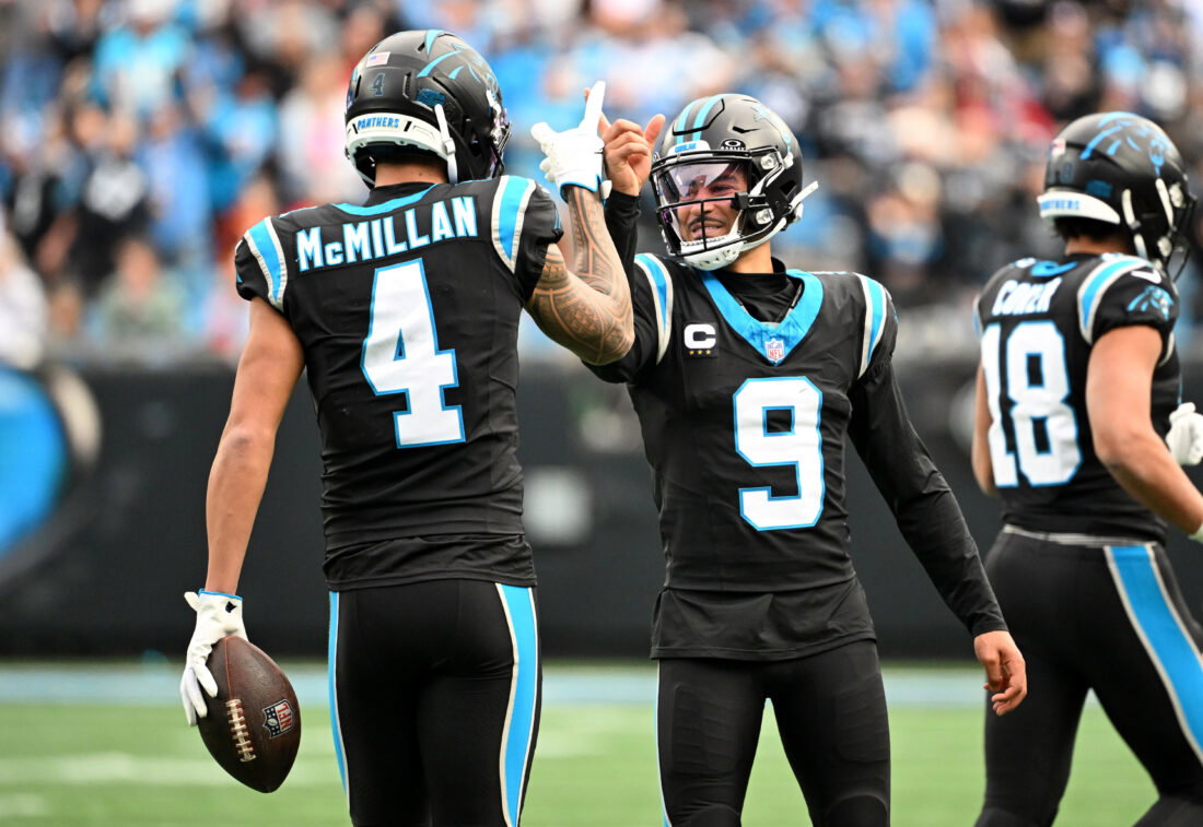 Dec 21, 2025; Charlotte, North Carolina, USA; Carolina Panthers quarterback Bryce Young (9) celebrates with wide receiver Tetairoa McMillan (4) after a play during the first half against the Tampa Bay Buccaneers at Bank of America Stadium. Mandatory Credit: Bob Donnan-Imagn Images