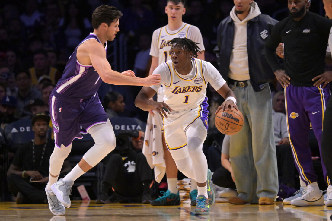 Dec 28, 2025; Los Angeles, California, USA; Sacramento Kings forward Doug McDermott (7) guards Los Angeles Lakers forward Adou Thiero (1) in the second half at Crypto.com Arena. Mandatory Credit: Jayne Kamin-Oncea-Imagn Images