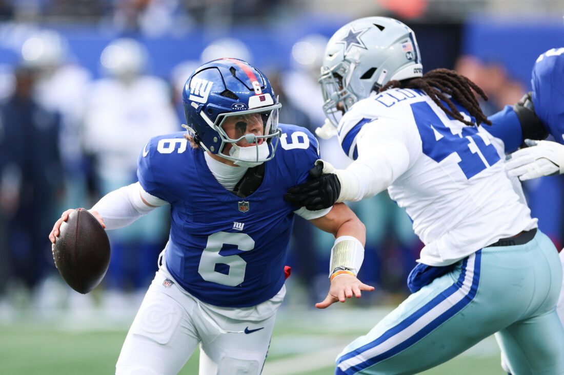 Jan 4, 2026; East Rutherford, New Jersey, USA; New York Giants quarterback Jaxson Dart (6) comes under pressure from Dallas Cowboys defensive end Jadeveon Clowney (42) during the first quarter at MetLife Stadium. Mandatory Credit: Vincent Carchietta-Imagn Images