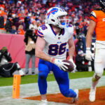 Jan 17, 2026; Denver, CO, USA; Buffalo Bills tight end Dalton Kincaid (86) celebrates after a touchdown against Denver Broncos safety Talanoa Hufanga (9) during the fourth quarter of an AFC Divisional Round playoff game at Empower Field at Mile High. Mandatory Credit: Ron Chenoy-Imagn Images