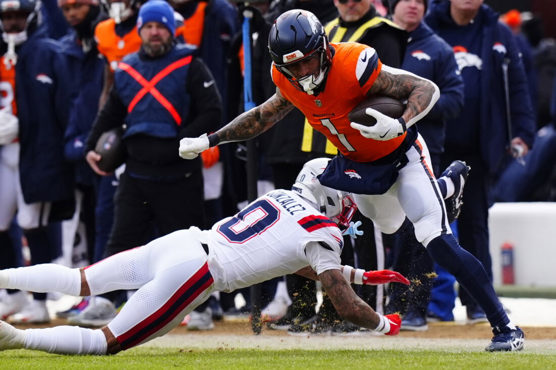Jan 25, 2026; Denver, CO, USA; Denver Broncos tight end Evan Engram (1) makes a catch against New England Patriots cornerback Christian Gonzalez (0) during the first half in the 2026 AFC Championship Game at Empower Field at Mile High. Mandatory Credit: Ron Chenoy-Imagn Images