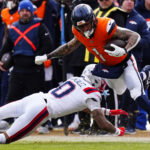 Jan 25, 2026; Denver, CO, USA; Denver Broncos tight end Evan Engram (1) makes a catch against New England Patriots cornerback Christian Gonzalez (0) during the first half in the 2026 AFC Championship Game at Empower Field at Mile High. Mandatory Credit: Ron Chenoy-Imagn Images