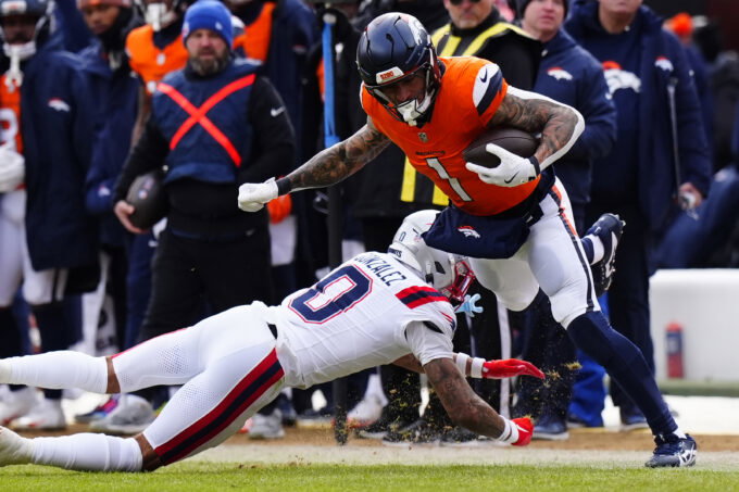 Jan 25, 2026; Denver, CO, USA; Denver Broncos tight end Evan Engram (1) makes a catch against New England Patriots cornerback Christian Gonzalez (0) during the first half in the 2026 AFC Championship Game at Empower Field at Mile High. Mandatory Credit: Ron Chenoy-Imagn Images