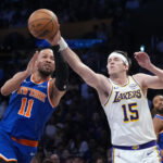 Mar 8, 2026; Los Angeles, California, USA; New York Knicks guard Jalen Brunson (11) and Los Angeles Lakers guard Austin Reaves (15) reach for the ball in the first half at Crypto.com Arena. Mandatory Credit: Kirby Lee-Imagn Images