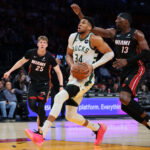 Mar 12, 2026; Miami, Florida, USA; Milwaukee Bucks forward Giannis Antetokounmpo (34) drives to the basket against Miami Heat center Bam Adebayo (13) during the first quarter at Kaseya Center. Mandatory Credit: Sam Navarro-Imagn Images
