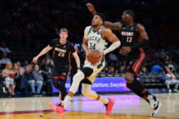 Mar 12, 2026; Miami, Florida, USA; Milwaukee Bucks forward Giannis Antetokounmpo (34) drives to the basket against Miami Heat center Bam Adebayo (13) during the first quarter at Kaseya Center. Mandatory Credit: Sam Navarro-Imagn Images