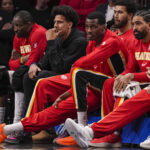 Mar 23, 2026; Atlanta, Georgia, USA; Atlanta Hawks forward Jalen Johnson (dark coat) on the bench with teammates during the game against the Memphis Grizzlies during the second half at State Farm Arena. Mandatory Credit: Dale Zanine-Imagn Images