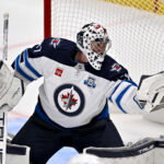 Apr 2, 2026; Dallas, Texas, USA; Winnipeg Jets goaltender Connor Hellebuyck (37) makes a glove save on a Dallas Stars shot during the second period at the American Airlines Center. Mandatory Credit: Jerome Miron-Imagn Images