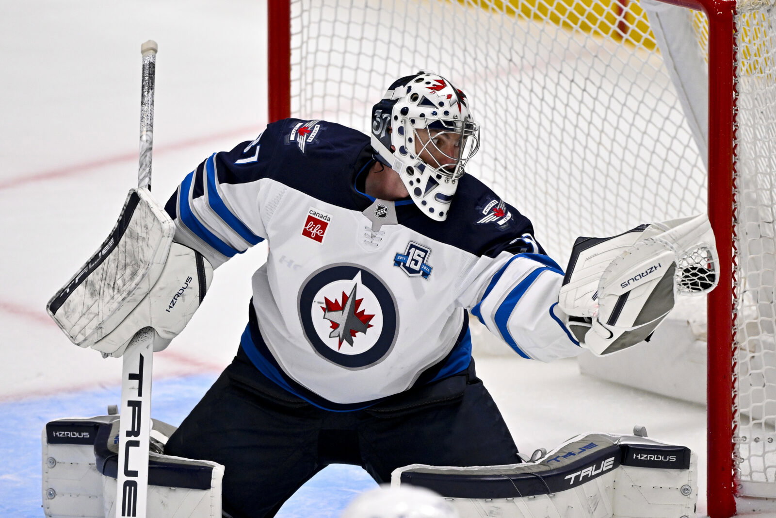 Apr 2, 2026; Dallas, Texas, USA; Winnipeg Jets goaltender Connor Hellebuyck (37) makes a glove save on a Dallas Stars shot during the second period at the American Airlines Center. Mandatory Credit: Jerome Miron-Imagn Images