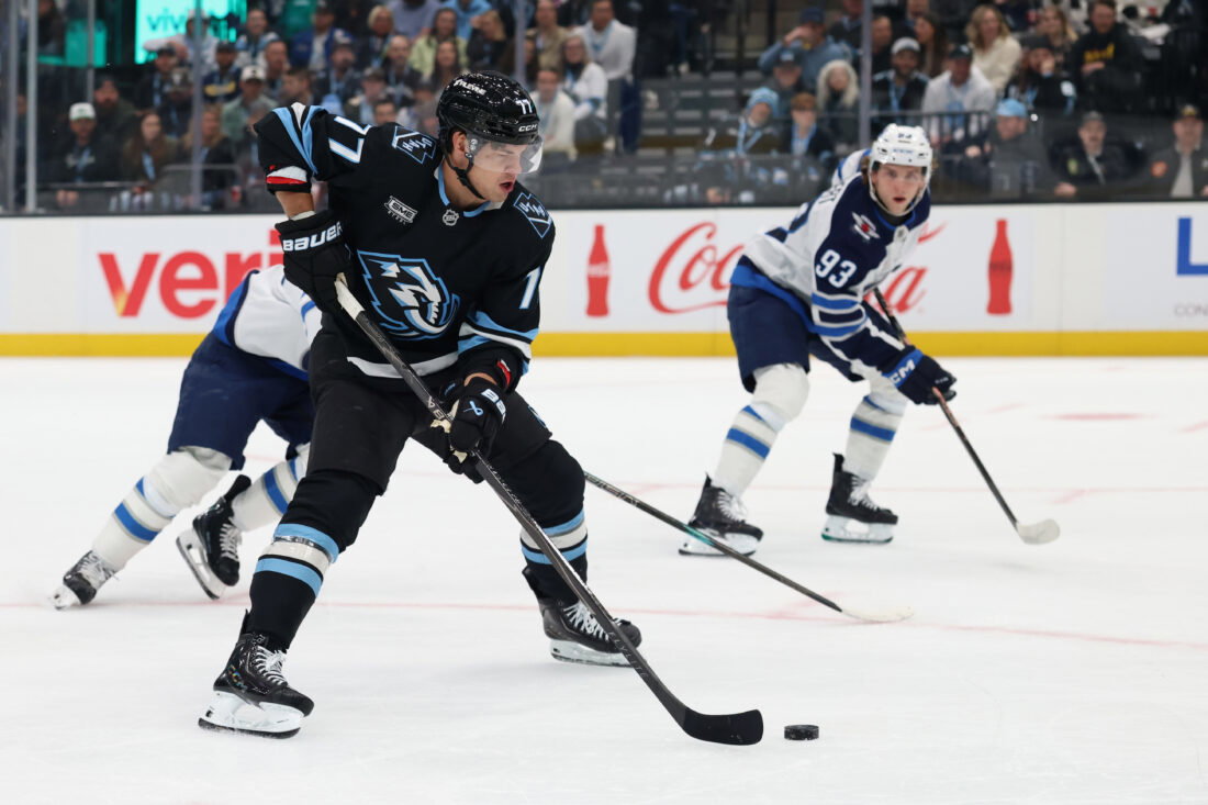 Apr 14, 2026; Salt Lake City, Utah, USA; Utah Mammoth right wing JJ Peterka (77) plays the puck against the Winnipeg Jets during the first period at Delta Center. Mandatory Credit: Rob Gray-Imagn Images