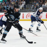 Apr 14, 2026; Salt Lake City, Utah, USA; Utah Mammoth right wing JJ Peterka (77) plays the puck against the Winnipeg Jets during the first period at Delta Center. Mandatory Credit: Rob Gray-Imagn Images