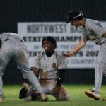 Oak Grove outfielder Eric 'EJ' Booth Jr. (3) is patted on the back after falling on the ground while catching a ball during the game against Northwest Rankin in Flowood, Miss., on Tuesday, March 24, 2026.