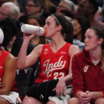 May 28, 2026; San Francisco, California, USA; Indiana Fever guard Caitlin Clark (22) drinks from her Gatorade bottle while resting on the bench with forward Monique Billings (25) and forward Grace VanSlooten (14) in the second quarter against the Golden State Valkyries at Chase Center. Mandatory Credit: David Gonzales-Imagn Images