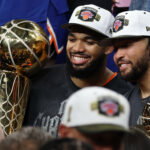 Jun 13, 2026; San Antonio, Texas, USA; New York Knicks center Karl-Anthony Towns (32) and Knicks guard Jalen Brunson (11) pose with the Larry O'Brien and Finals MVP trophies, respectively, during the championship trophy ceremony after game five of the 2026 NBA Finals against the San Antonio Spurs at Frost Bank Center. Mandatory Credit: Geoff Burke-Imagn Images