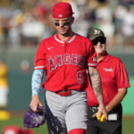 Jun 20, 2026; West Sacramento, California, USA; Los Angeles Angels shortstop Zach Neto (9) walks on the field while carrying a Pikachu figure before the game against the Athletics at Sutter Health Park. Mandatory Credit: Darren Yamashita-Imagn Images