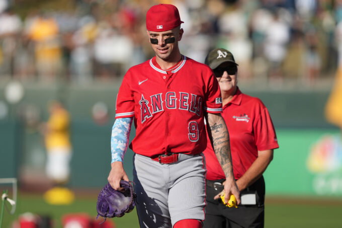 Jun 20, 2026; West Sacramento, California, USA; Los Angeles Angels shortstop Zach Neto (9) walks on the field while carrying a Pikachu figure before the game against the Athletics at Sutter Health Park. Mandatory Credit: Darren Yamashita-Imagn Images