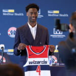 Jun 25, 2026; Washington, DC, USA; Washington Wizards first round draft pick and number one overall pick AJ Dybantsa poses for a photo with his jersey during a press conference at InterContinental Hotel. Mandatory Credit: Amber Searls-Imagn Images