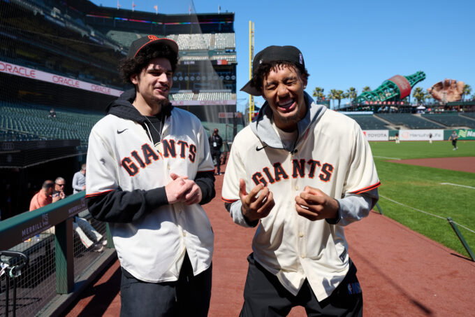 Jun 27, 2026; San Francisco, California, USA; Golden State Warriors 2026 NBA Draft picks Yaxel Lendeborg (right) and Lajae Jones react before a game between the Atlanta Braves and San Francisco Giants at Oracle Park. Mandatory Credit: Robert Edwards-Imagn Images