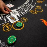 A table games dealer places cards on a blackjack table.