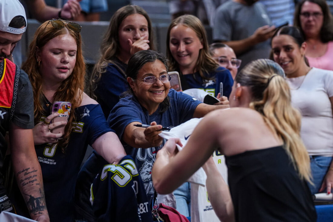Jul 2, 2026; Hartford, Connecticut, USA; Dallas Wings guard Paige Bueckers (5) signs autographs after warming up before the start of the game against the Connecticut Sun at PeoplesBank Arena. Mandatory Credit: David Butler II-Imagn Images