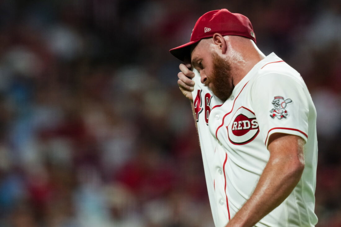 Jul 7, 2026; Cincinnati, Ohio, USA; Cincinnati Reds pitcher Caleb Ferguson (46) wipes his face as walks to the dugout after being pulled from the game against the Philadelphia Phillies in the eighth inning at Great American Ball Park. Mandatory Credit: Aaron Doster-Imagn Images