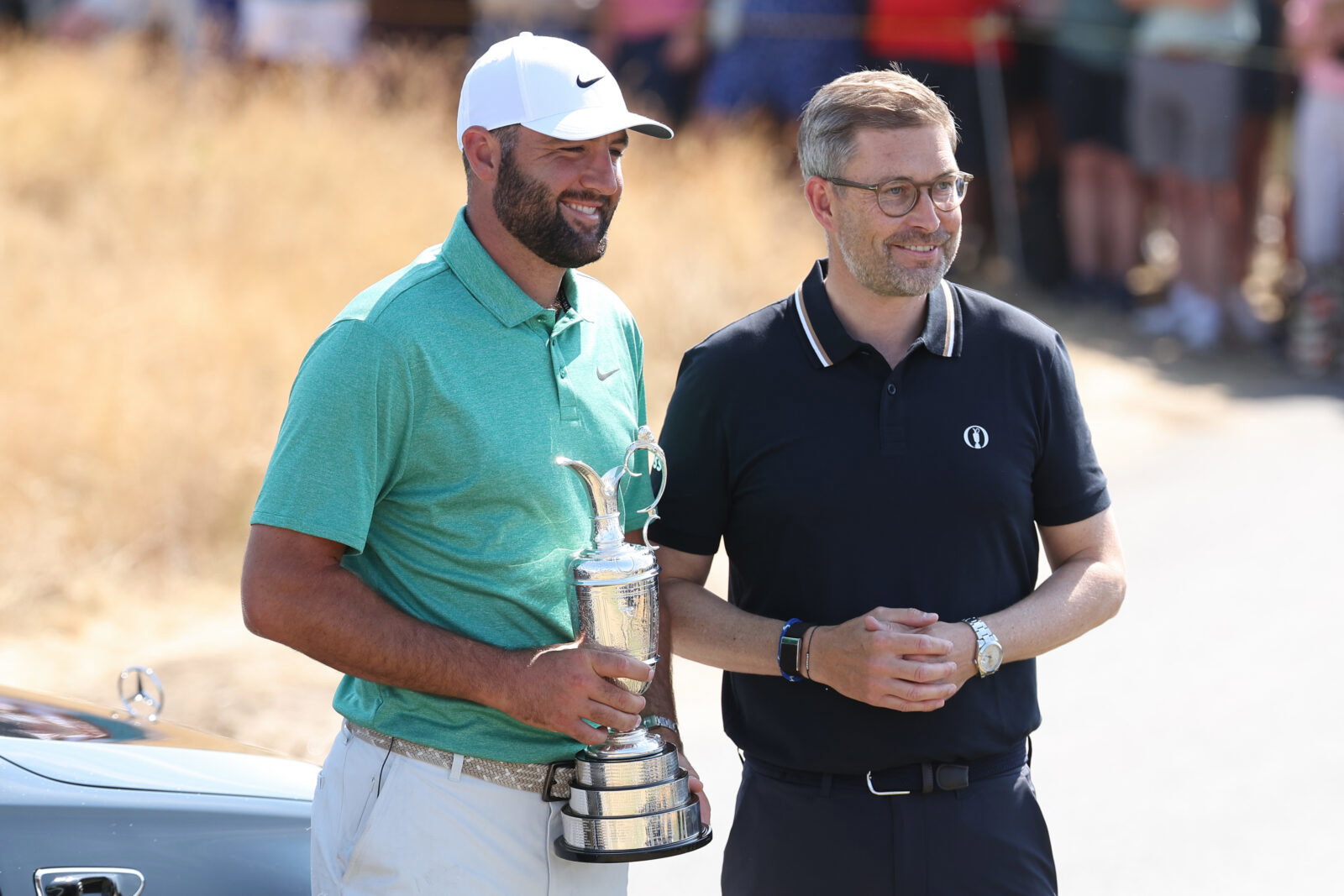 Jul 14, 2026; Southport, England; Scottie Scheffler returns the Claret Jug to CEO of The R&A Mark Darbon (R) in a ceremony during a practice day for The Open Championship golf tournament at Royal Birkdale. Mandatory Credit: Bill Streicher-Imagn Images