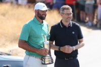 Jul 14, 2026; Southport, England; Scottie Scheffler returns the Claret Jug to CEO of The R&A Mark Darbon (R) in a ceremony during a practice day for The Open Championship golf tournament at Royal Birkdale. Mandatory Credit: Bill Streicher-Imagn Images