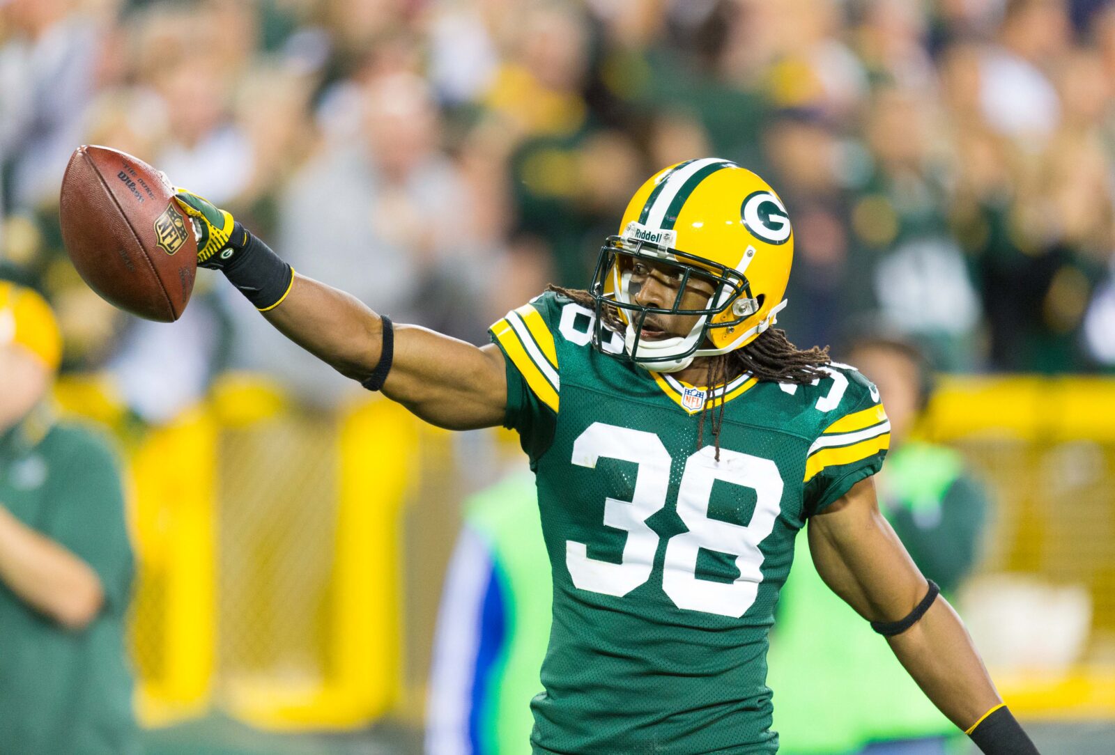 Sep 13, 2012; Green Bay, WI, USA; Green Bay Packers cornerback Tramon Williams (38) celebrates an interception during the game against the Chicago Bears at Lambeau Field. The Packers defeated the Bears 23-10. Mandatory Credit: Jeff Hanisch-USA TODAY Sports