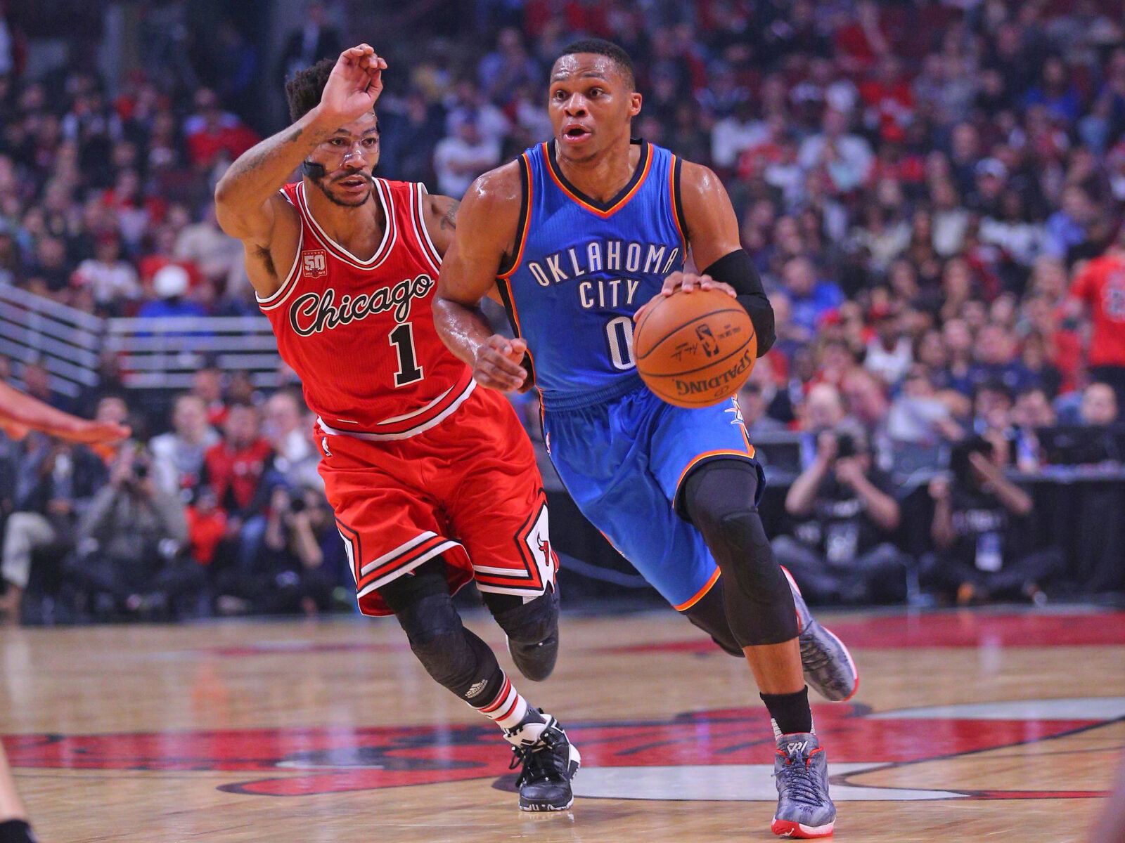 Nov 5, 2015; Chicago, IL, USA; Oklahoma City Thunder guard Russell Westbrook (0) dribbles the ball past Chicago Bulls guard Derrick Rose (1) during the first half at the United Center. Mandatory Credit: Dennis Wierzbicki-USA TODAY Sports