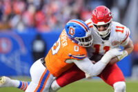 Jan 5, 2025; Denver, Colorado, USA; Denver Broncos linebacker Jonathon Cooper (0) sacks Kansas City Chiefs quarterback Carson Wentz (11) in the second quarter at Empower Field at Mile High. Mandatory Credit: Ron Chenoy-Imagn Images