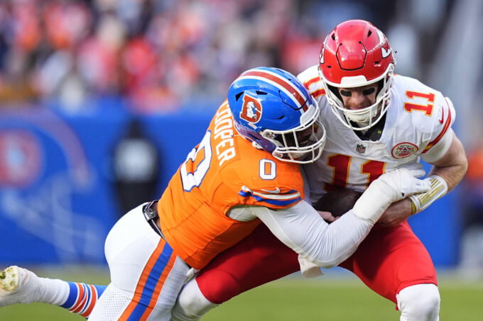 Jan 5, 2025; Denver, Colorado, USA; Denver Broncos linebacker Jonathon Cooper (0) sacks Kansas City Chiefs quarterback Carson Wentz (11) in the second quarter at Empower Field at Mile High. Mandatory Credit: Ron Chenoy-Imagn Images