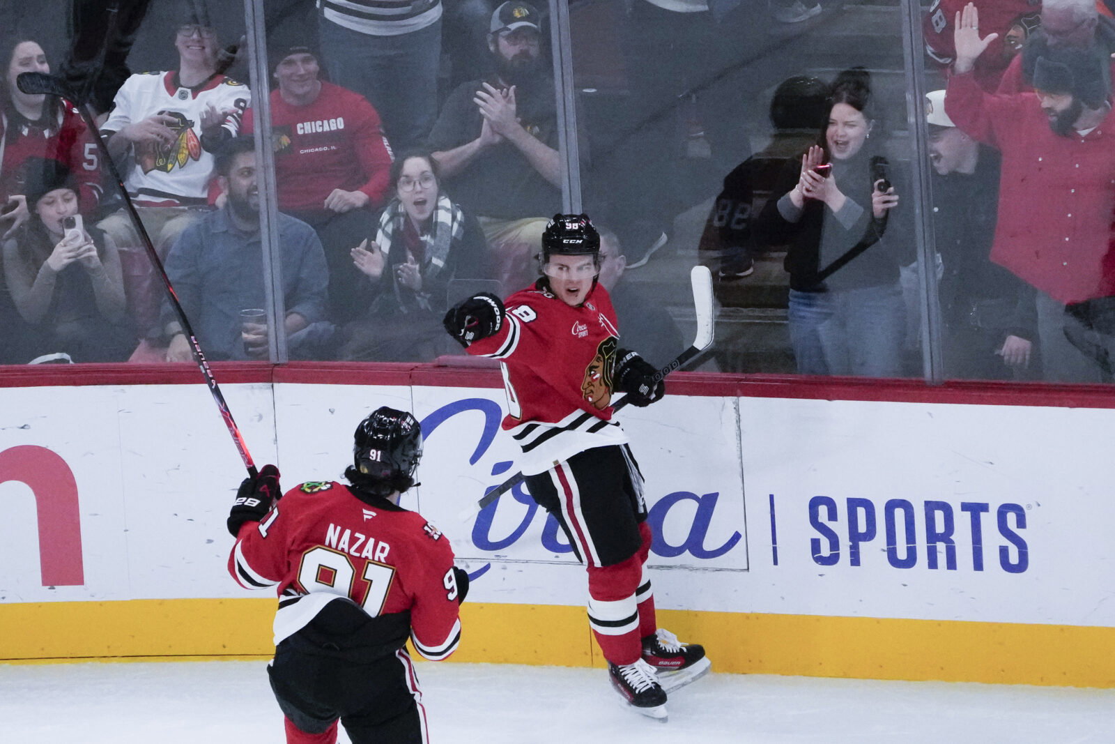 Oct 28, 2025; Chicago, Illinois, USA; Chicago Blackhawks center Connor Bedard (98) celebrates his goal against the Ottawa Senators with center Frank Nazar (91) during the first period at United Center. Mandatory Credit: David Banks-Imagn Images