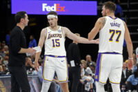 Oct 31, 2025; Memphis, Tennessee, USA; Los Angeles Lakers head coach JJ Redick talks with guard Austin Reaves (15) and guard Luka Doncic (77) during the fourth quarter against the Memphis Grizzlies at FedExForum. Mandatory Credit: Petre Thomas-Imagn Images