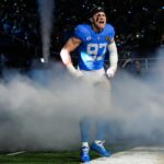 Detroit Lions defensive end Aidan Hutchinson (97) runs onto the field for players introduction before the Thanksgiving game against Green Bay Packers at Ford Field in Detroit on Thursday, Nov. 27, 2025.